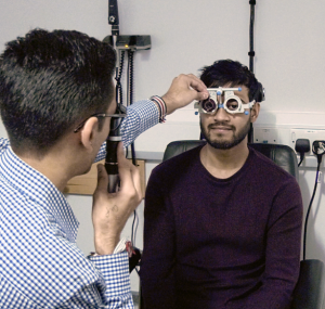 Optometrist checking if you need glasses