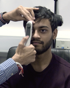 Optometrist performing eye pressure check
