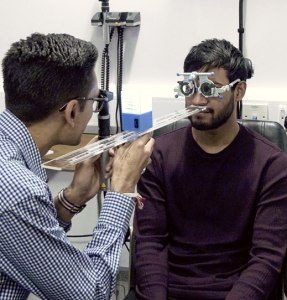 Optometrist checking eye focusing ability