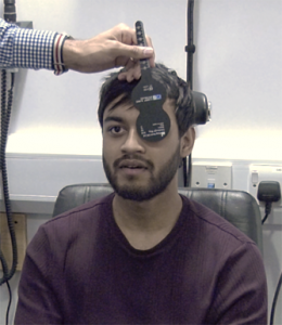 Optometrist checking vision using an eye chart