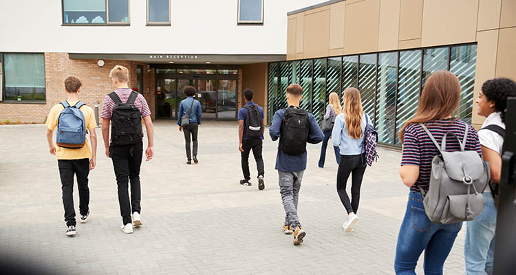 Students walking into a school building.