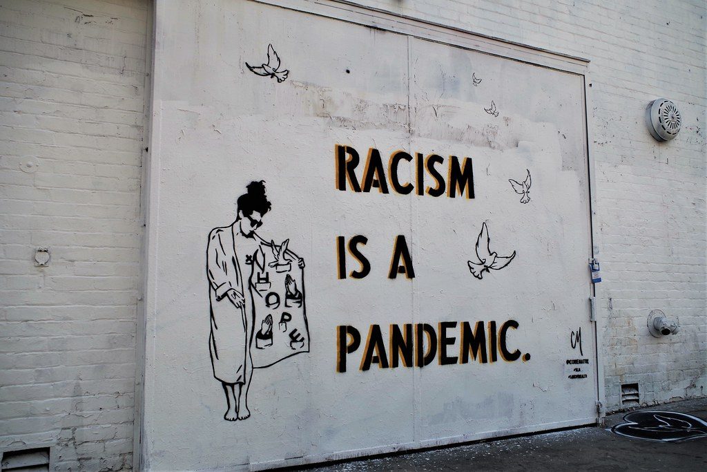 Grafitti says "Racism is a pandemic"