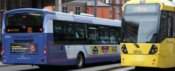 Image showing a yellow tram and blue singe decker bus in Greater Manchester