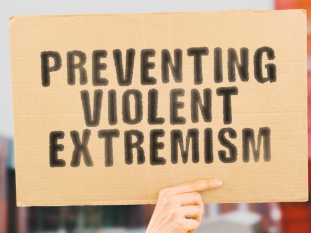 A sign that reads ‘preventing violent extremism’.