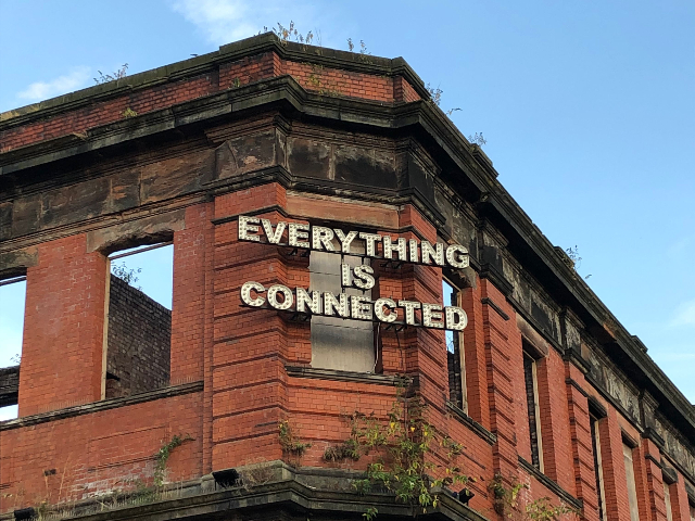 A building with the words ‘everything is connected’ on it