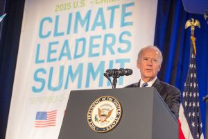 Joe Biden at a podium in front of a banner reading 'Climate Leaders' Summit'