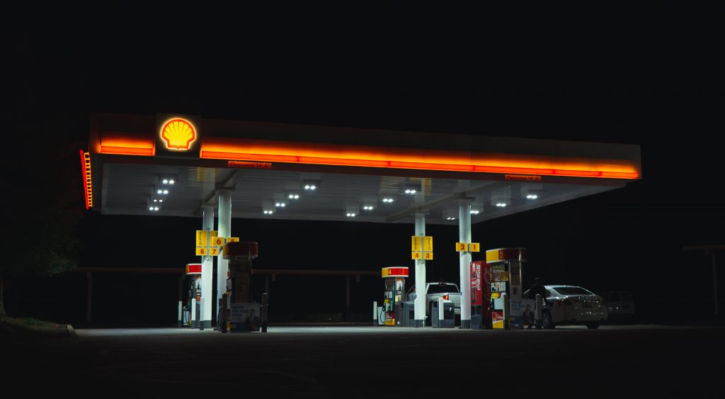 A petrol station's lights glow amid a surrounding darkness