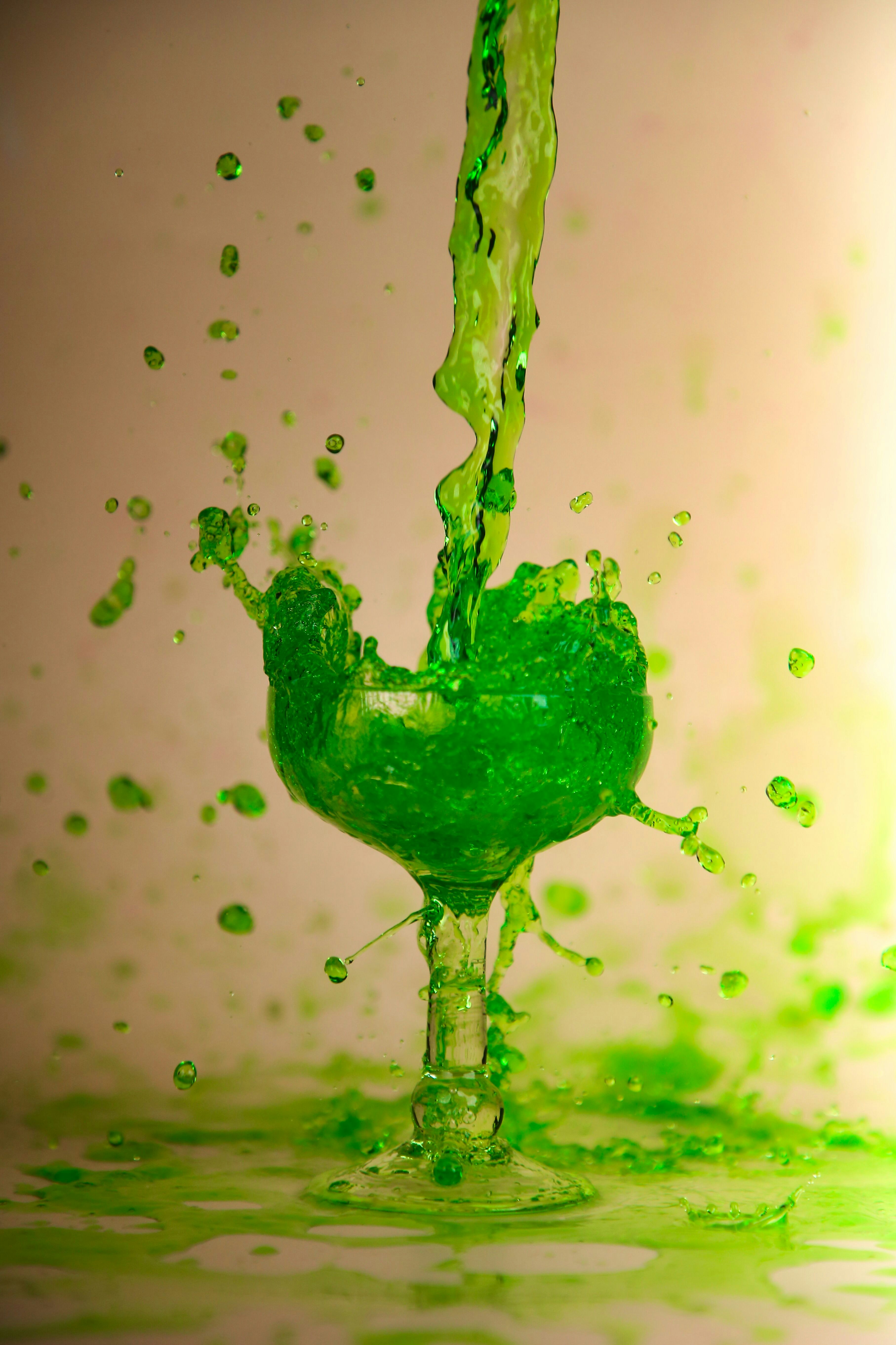 Green liquid forming a glass shape