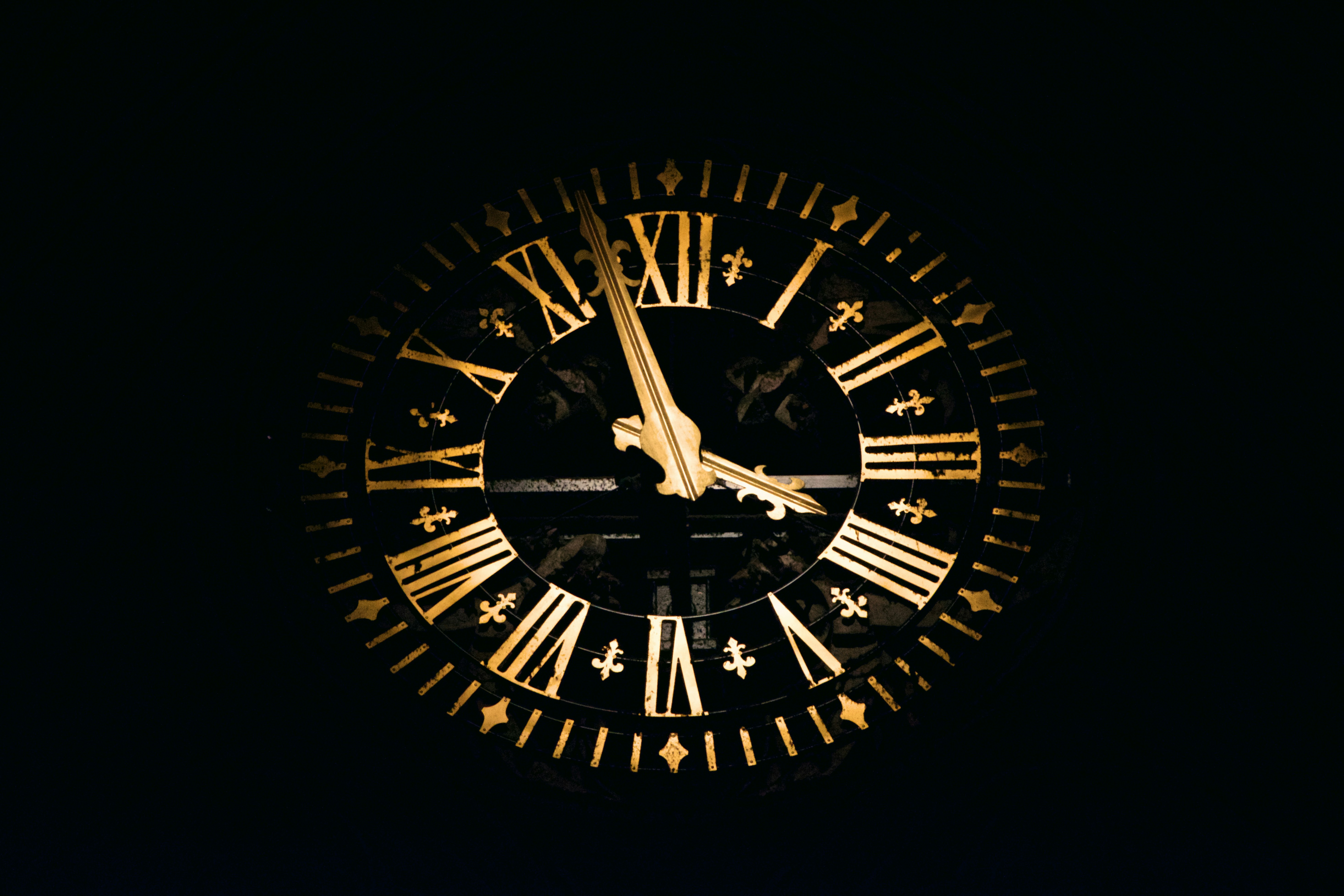 An old fashioned clock in dark shadow