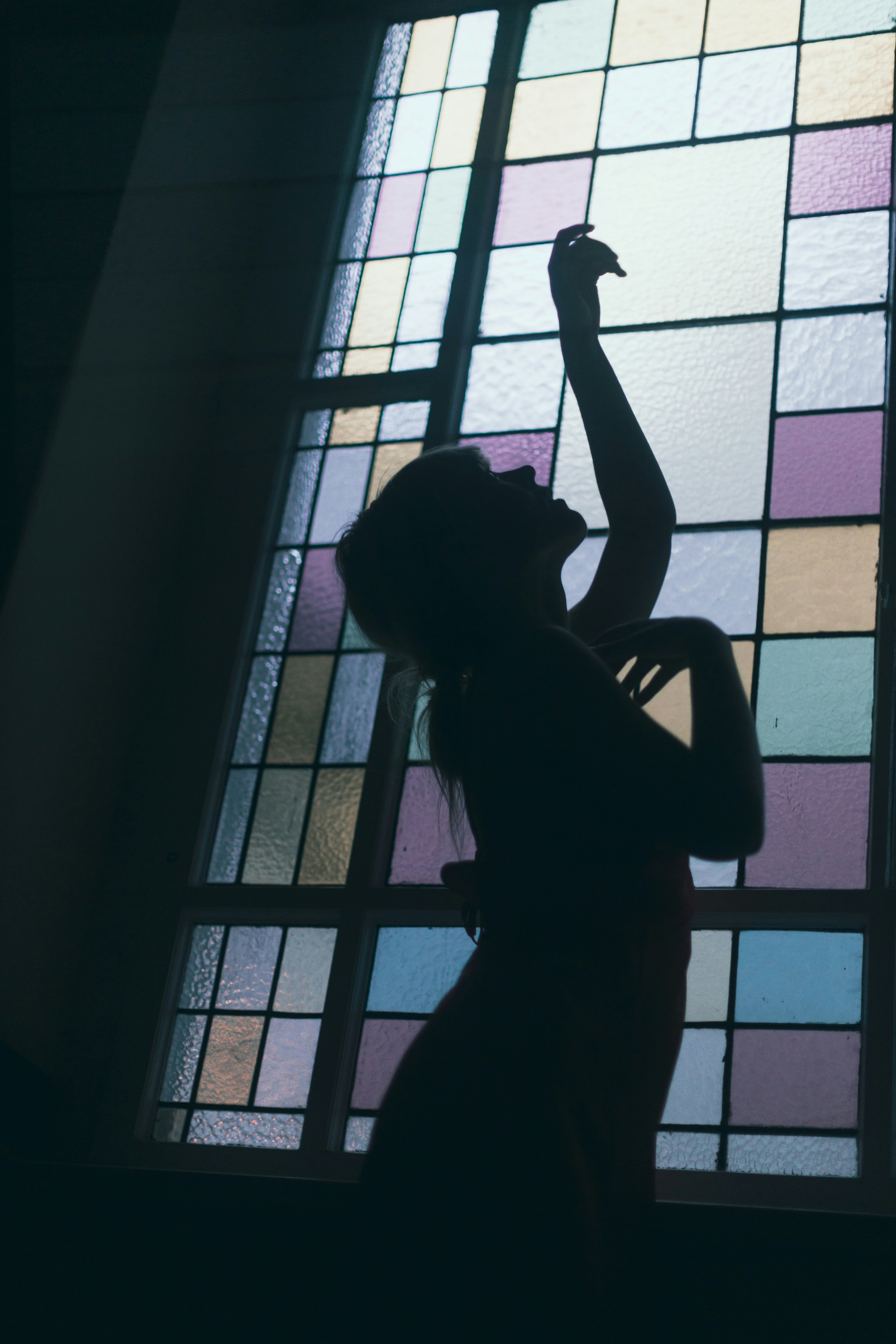 Ella rapha-wilde-K1MC37g8R_k-unsplash The figure of a woman next to a stained glass window