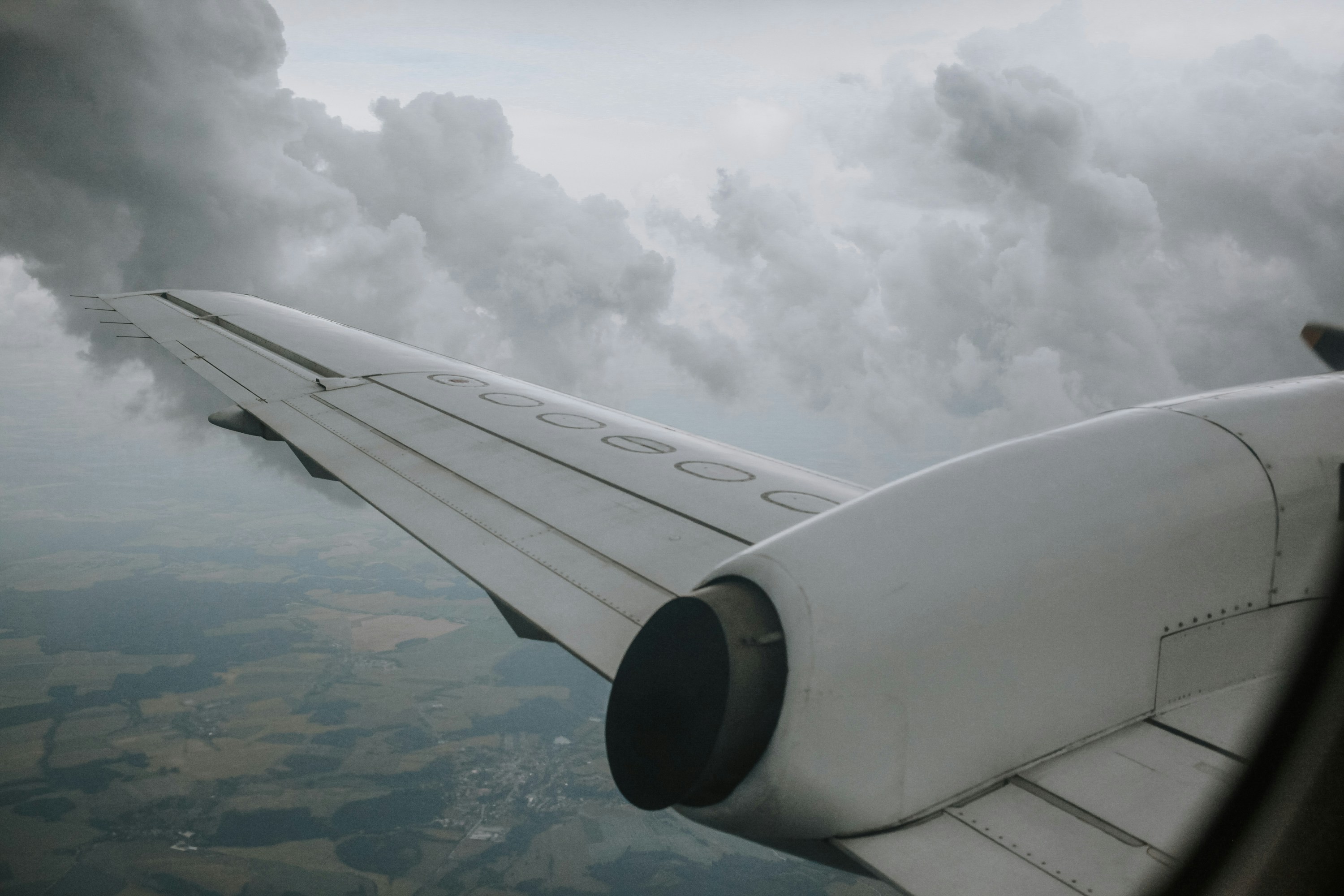 Zohaib stockholm-paris-studio-s-yQ1lHo6Ek-unsplash A plan wing and smoke coming from the plane