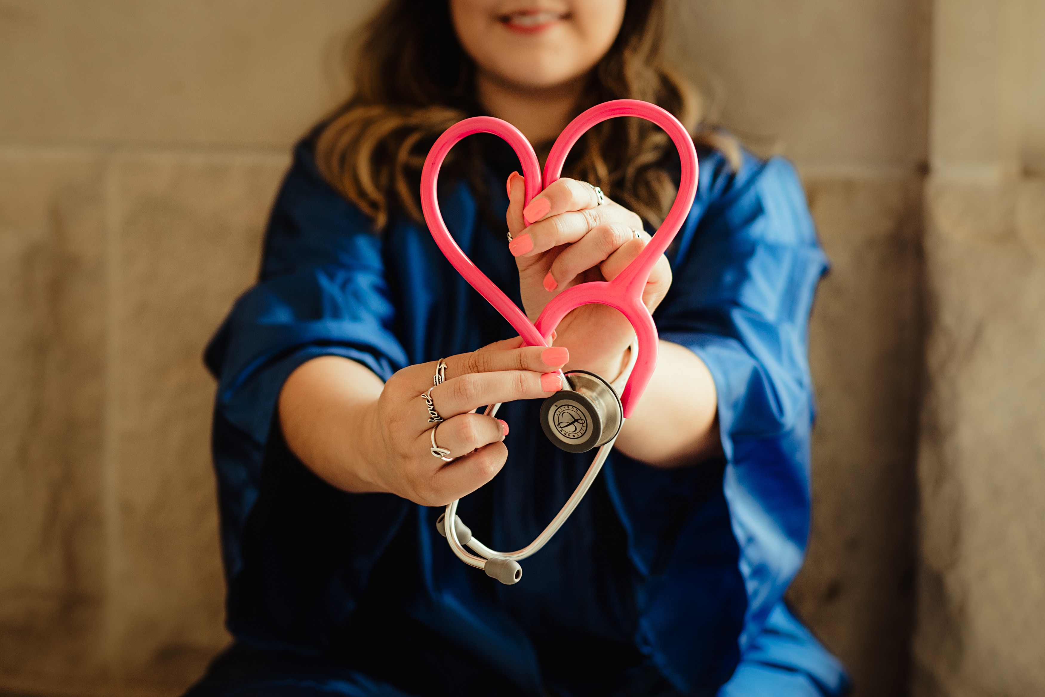 Health Professional – Photo by Patty Brito on Unsplash Young women sitting down in medical scrubs holding a stethoscope shaped like a heart