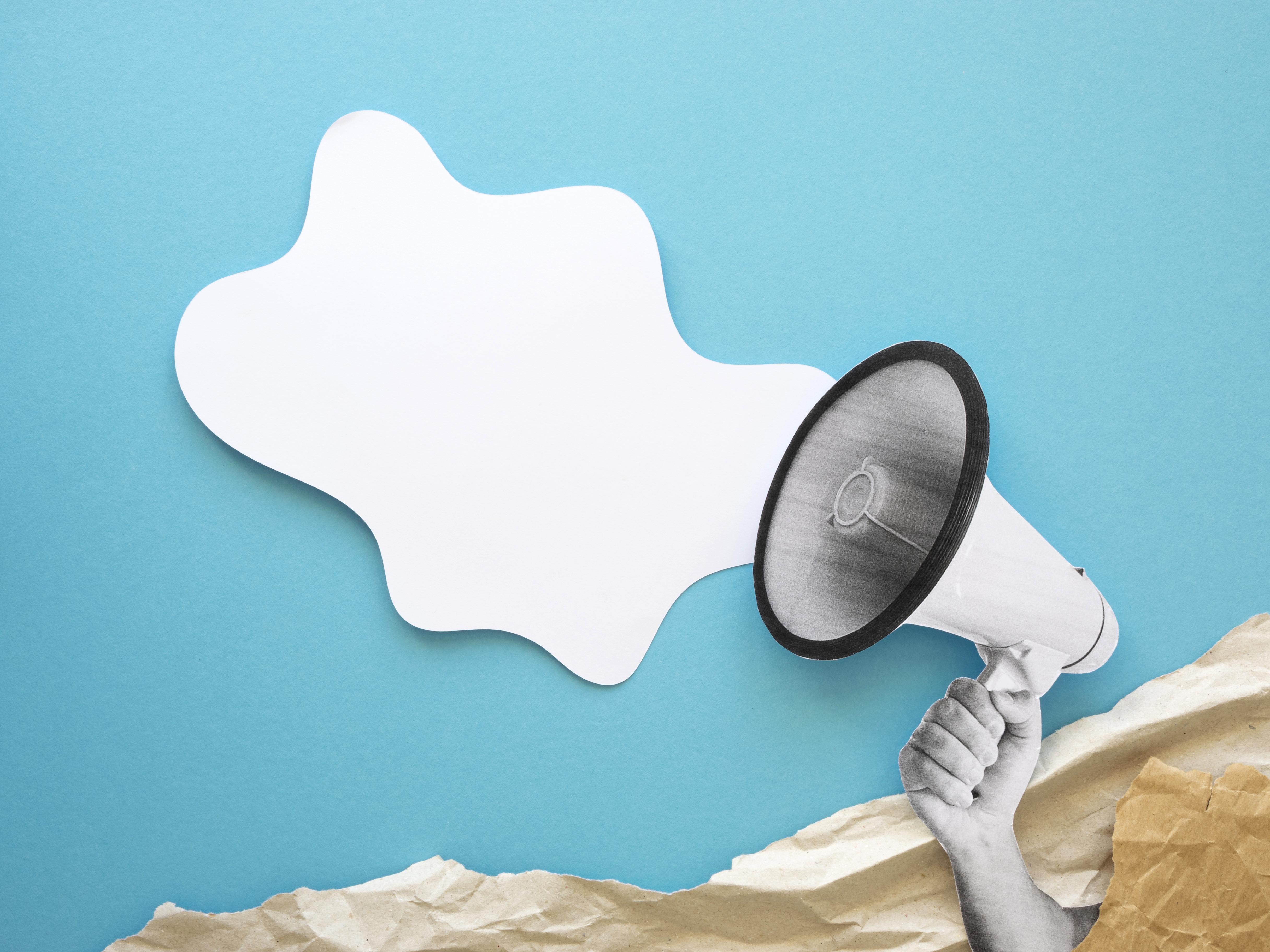 Hand holding a megaphone on a blue background