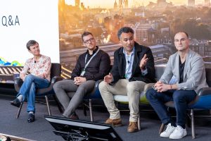 A panel of speakers onstage.