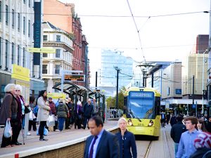 A tram arriving at a tram stop in central Manchester