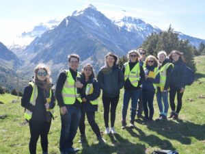 Group of Geography students in front of mountain range on fieldtrip