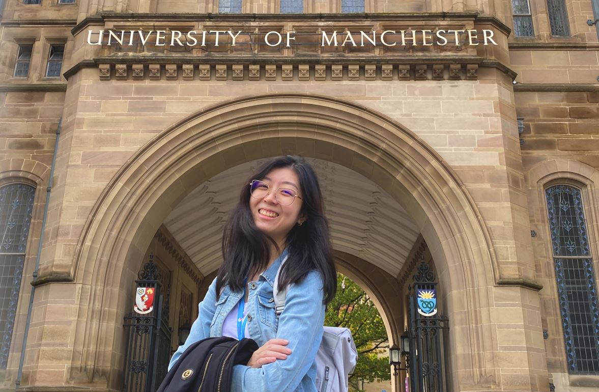 allison Girl smiling stand in front of the university of manchester building
