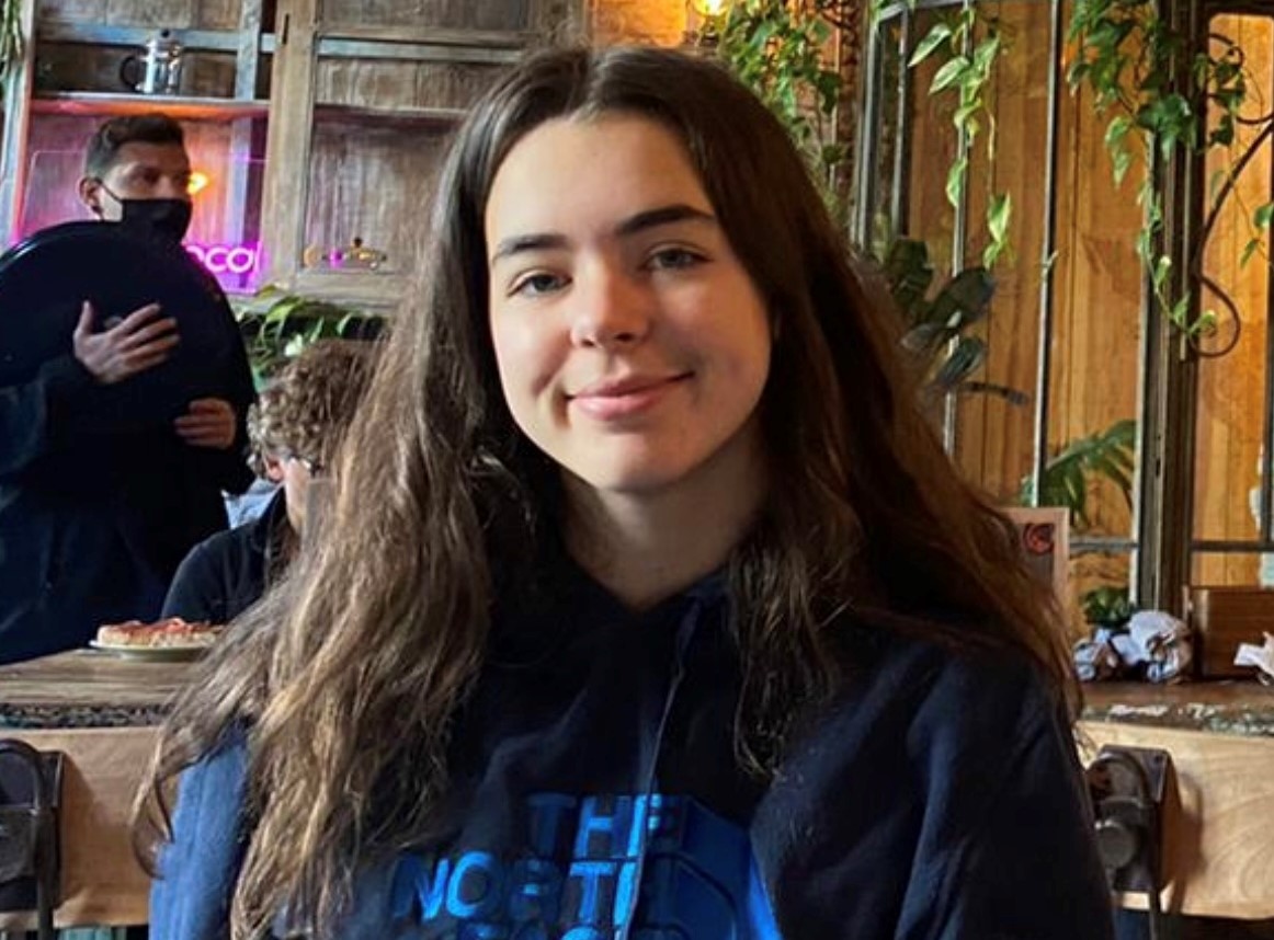 Brunette girl in a cafe smiling at camera