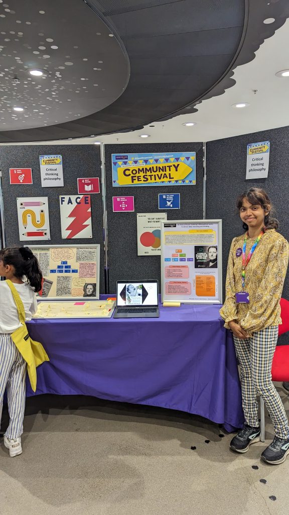 Masheshi at the Community Festival displaying her research