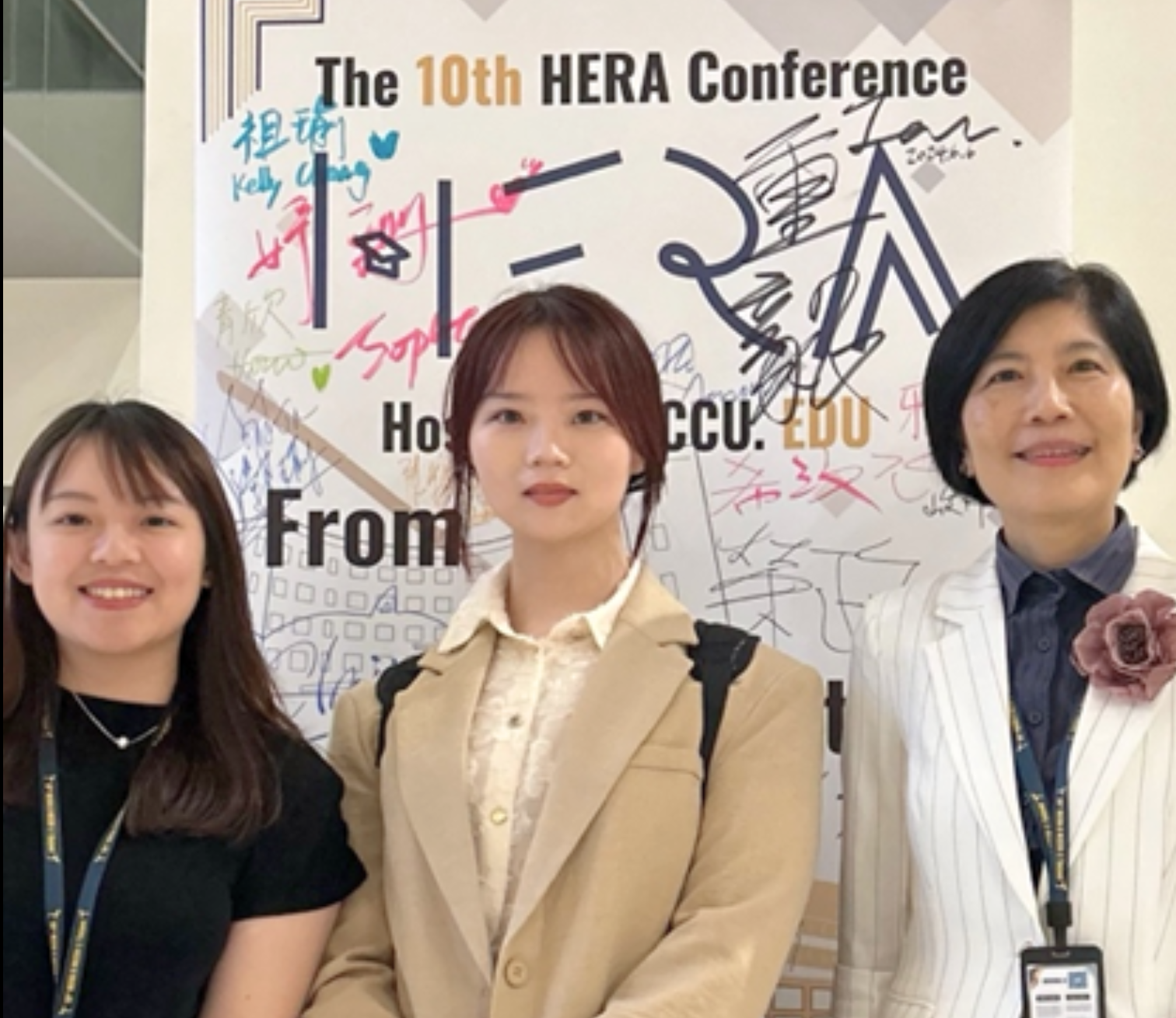 Zhuo Sun and Conference Delegates in front of banner