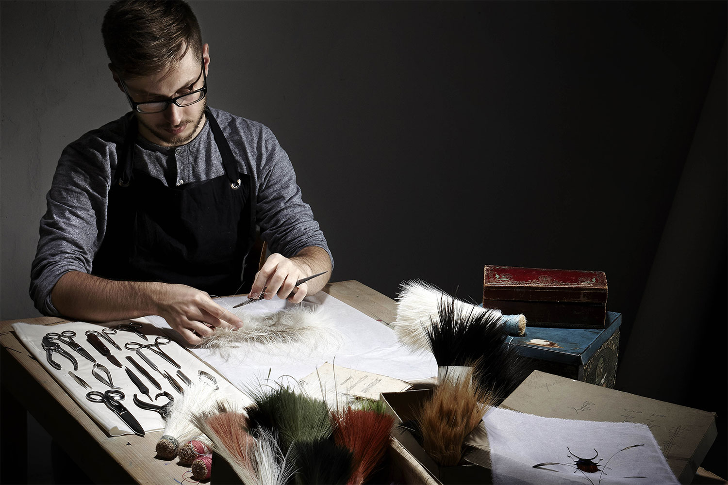 Fig.1 Man working with feathers