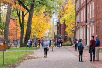 Blurred background of a university campus on an autumn day.