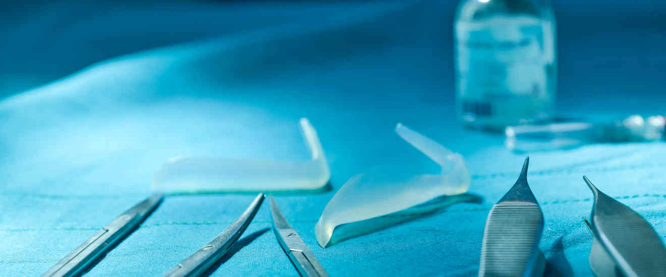 A photo of scalpels and a bottle.