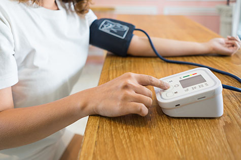 Woman measuring her blood pressure