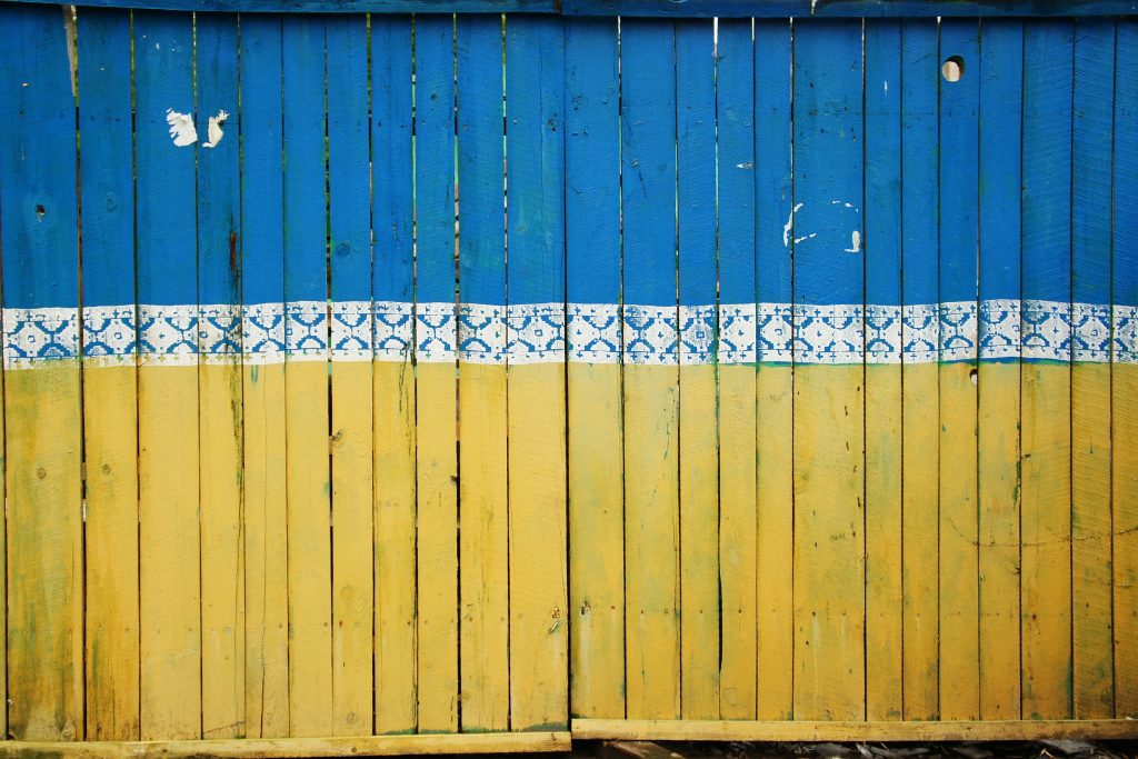 Wooden fence panel painted with the Ukrainian flag