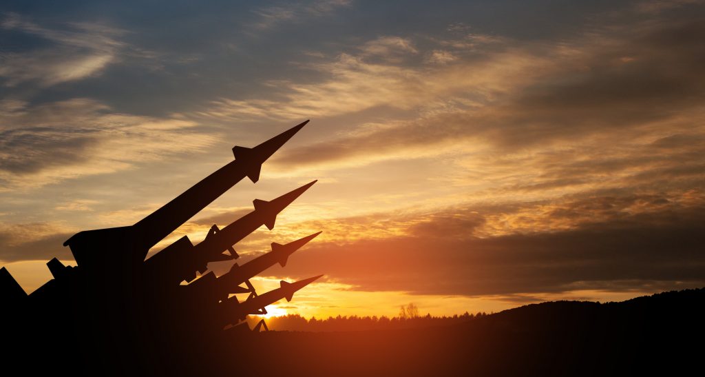 Stock image of missiles aimed at the sky at sunset