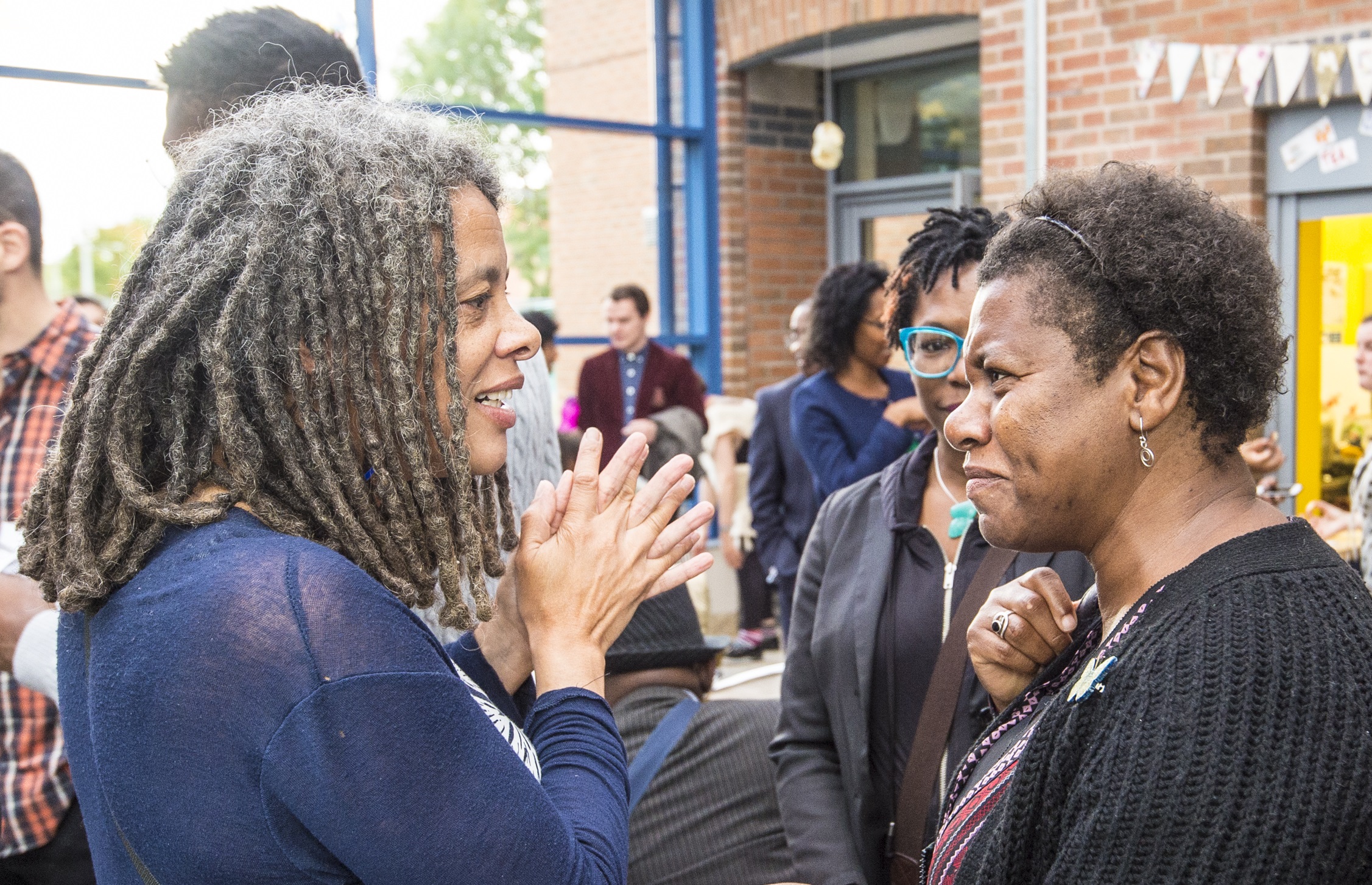 Women talking at an event.